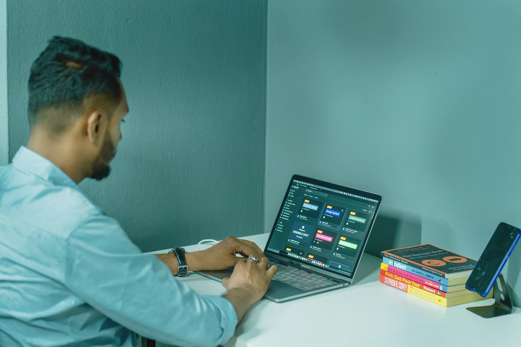 Designer workstation with a laptop and layout boards